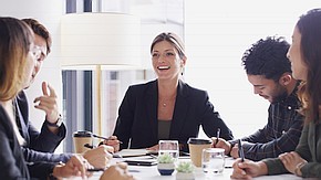 Female leader surrounded by a team